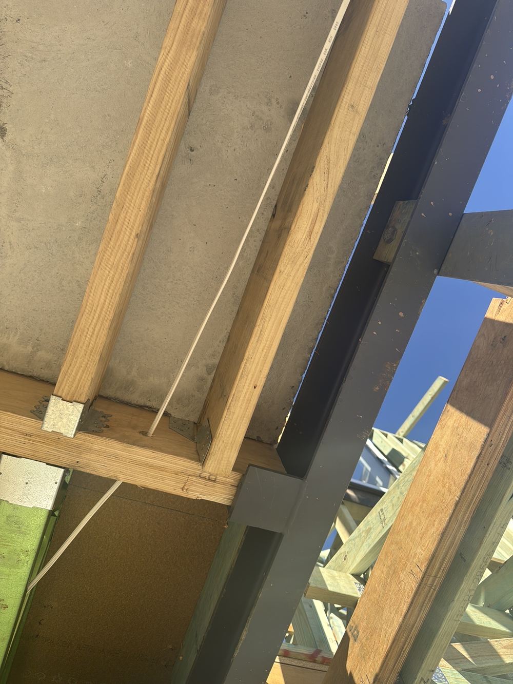 Beam connection built differently from the engineering detail, awaiting rectification or certification, found during a frame inspection in Gables