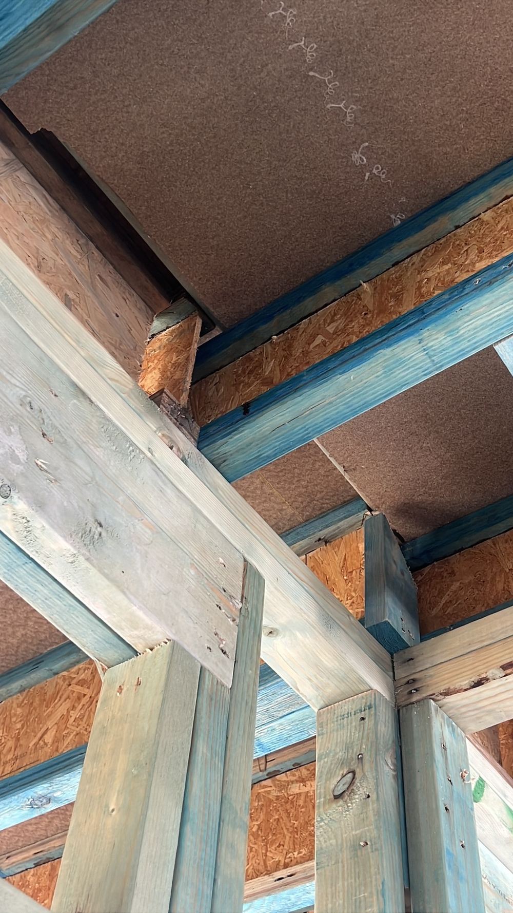 Split and damaged floor joist that needs repair or replacement before lining, Gables
