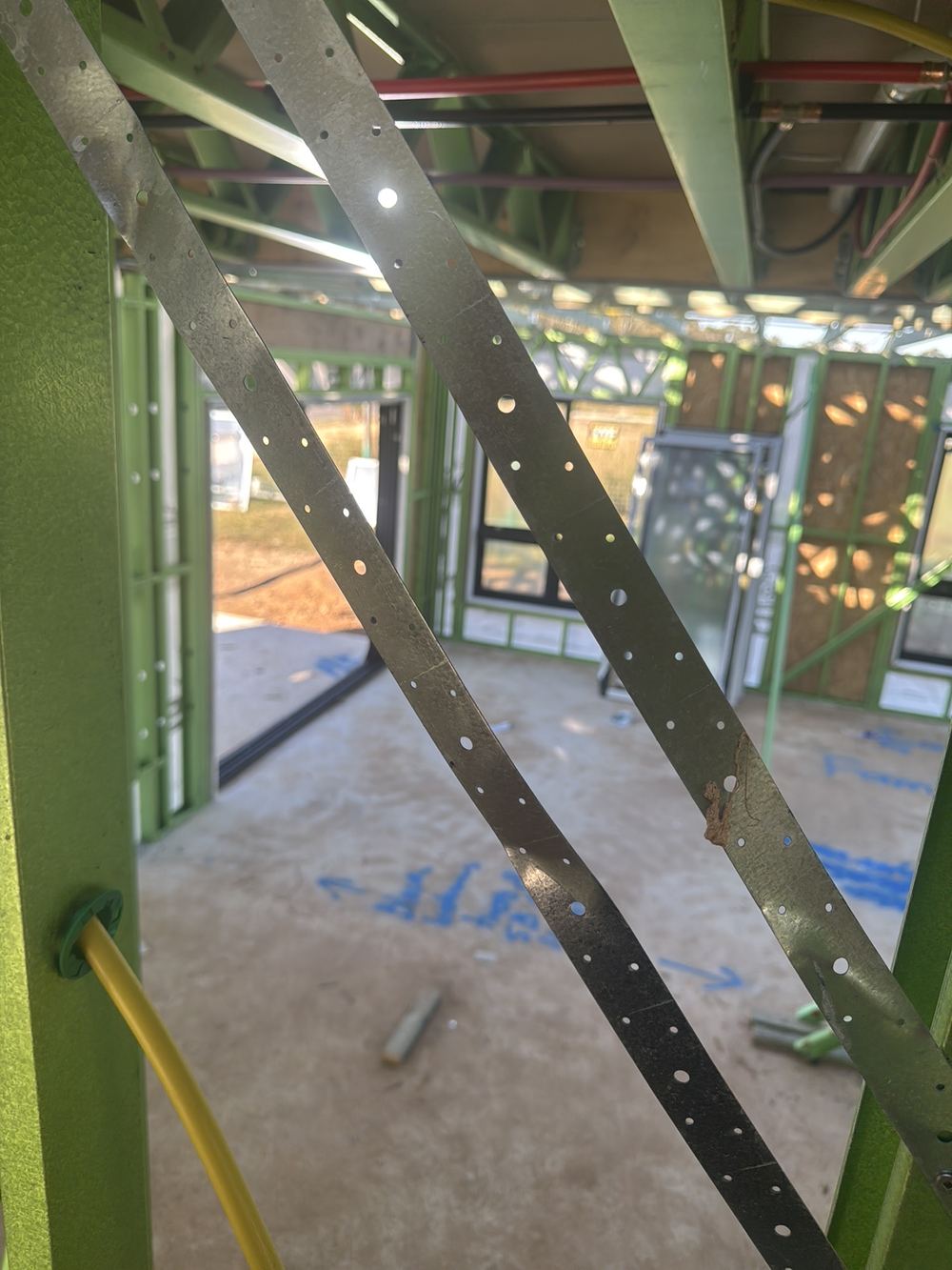 Metal strap bracing left slack, so it cannot brace the wall as designed, found during a frame inspection in Gables