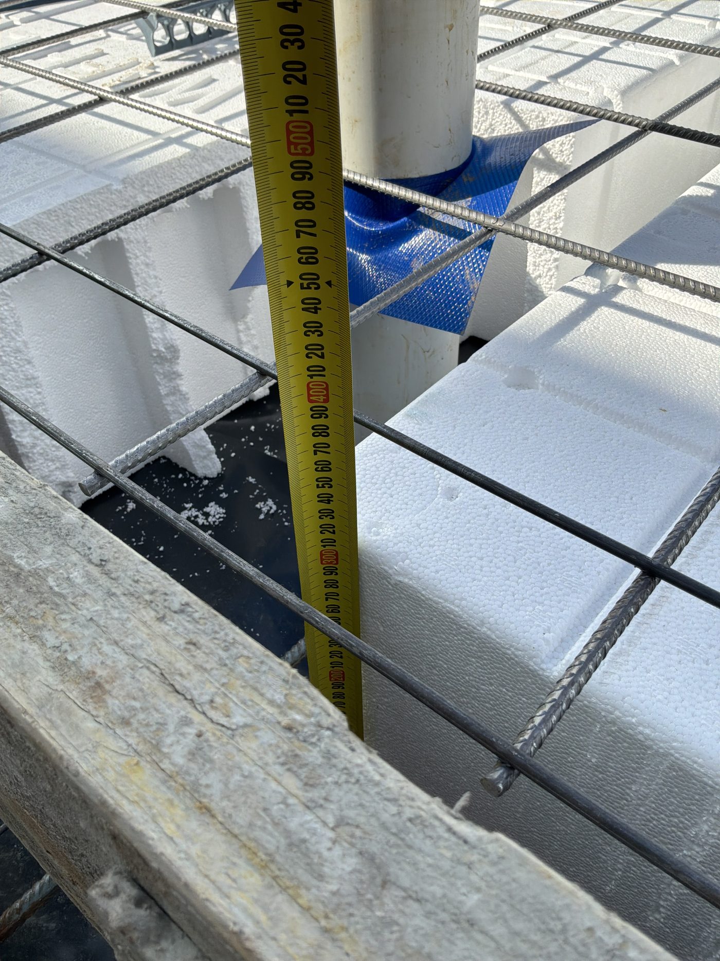 Waffle pod slab set out ahead of the pour, with beam spacing being checked, found during a slab pre-pour inspection in Gables
