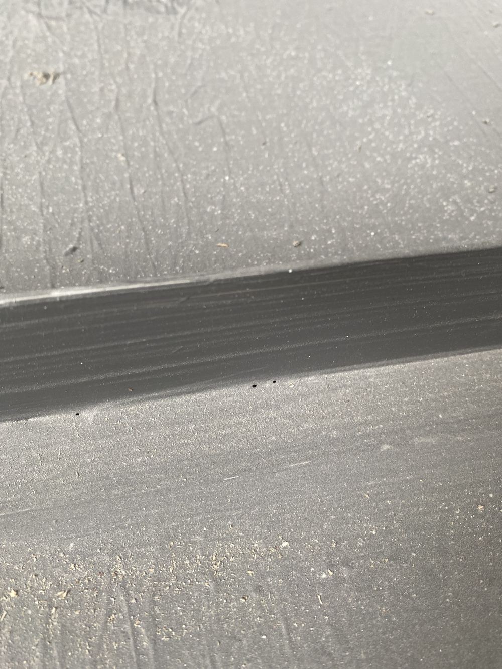 Small pinholes across a shower recess membrane that compromise its seal, found during a waterproofing inspection in Gables